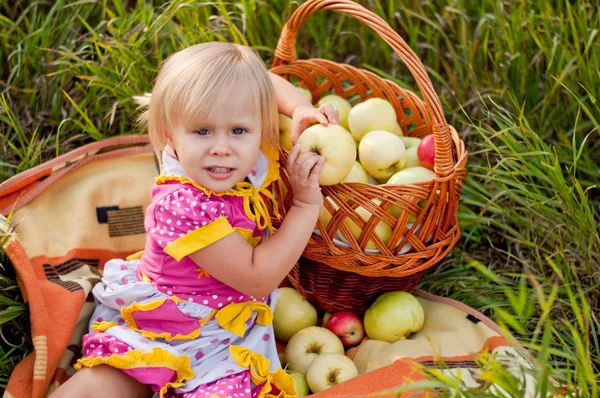 Menina com uma cesta de maçãs frescas — Fotografia de Stock