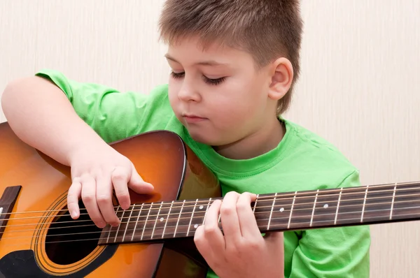 Bir çocuk gitar çalmayı öğrenir. — Stok fotoğraf