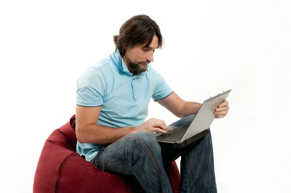 A man with a laptop on a light background Royalty Free Stock Photos