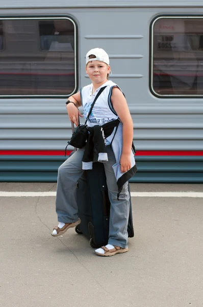 Rapaz com saco de viagem perto do comboio — Fotografia de Stock