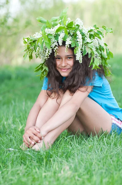 Menina adolescente com uma coroa de flores de cereja na cabeça — Fotografia de Stock