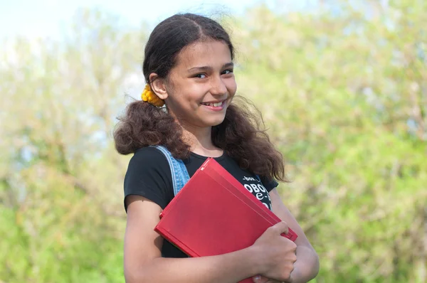 Teen girl with books on nature — Stock Photo, Image