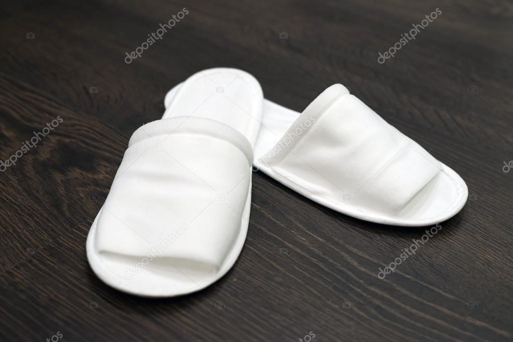 Disposable slippers on the floor in the hotel