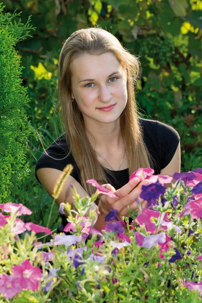 Teenager-Mädchen auf einem Hintergrund von Blumen — Stockfoto