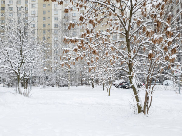 Snowy courtyard with car in Moscow, Russia