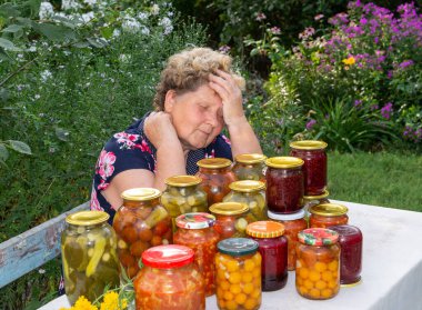 Woman with a homemade canned vegetables clipart