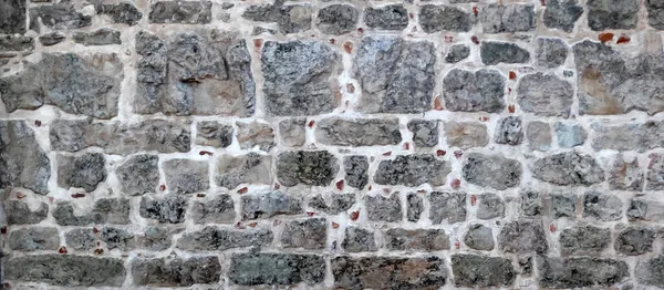 Antik Evin Duvarının Farklı Boyutlarda Gri Taşlardan Yapılmış Bir Parçası — Stok fotoğraf