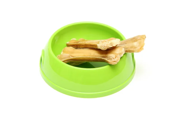 Dog dish with food garnished with bone isolated on white — Stock Photo, Image