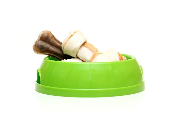 Dog dish with food garnished with bone isolated on white — Stock Photo, Image