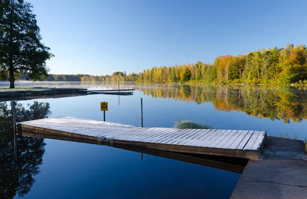 Wooden frosty bridge on the lake — Stock Photo, Image