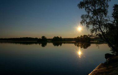 İsveç gölü gündoğumu ayna yansıması ile