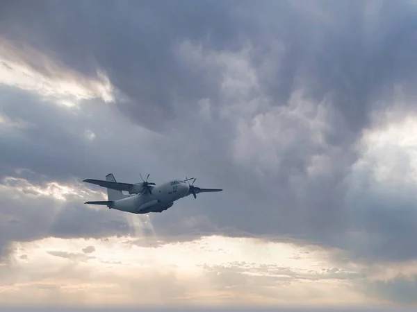 military airplane against grey sky