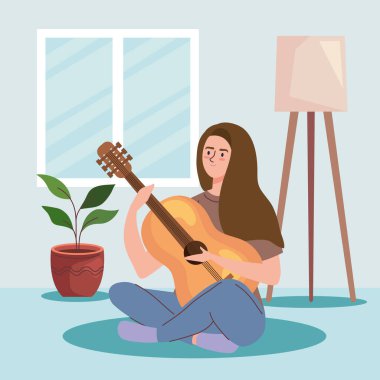 Kadın odada gitar çalıyor.