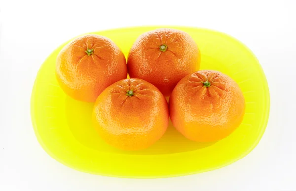 Tangerines on yellow plate — Stock Photo, Image