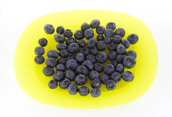 Blueberries on yellow plate — Stock Photo, Image