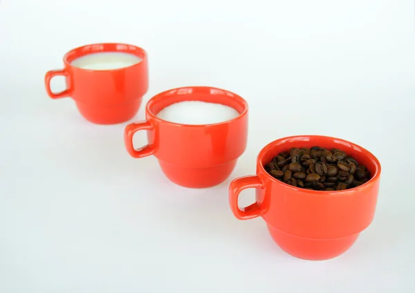 Three cups with coffee sugar and milk — Stock Photo, Image