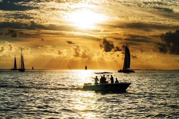 Sailboat and disherman at sunset — Stock Photo, Image