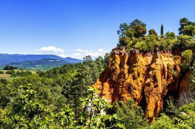 ochre cliffs near Roussillon, Provence, France clipart