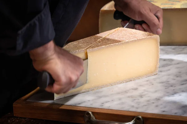 Man Cuts Portion Gruyere Wire Famous Swiss Cheese Cellar Marble — Stock Photo, Image