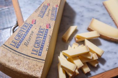 July 11 2022, Lyon, France : Switzerland cheese : Le Gruyere Reserve, famous swiss cheese in a cellar on a marble background