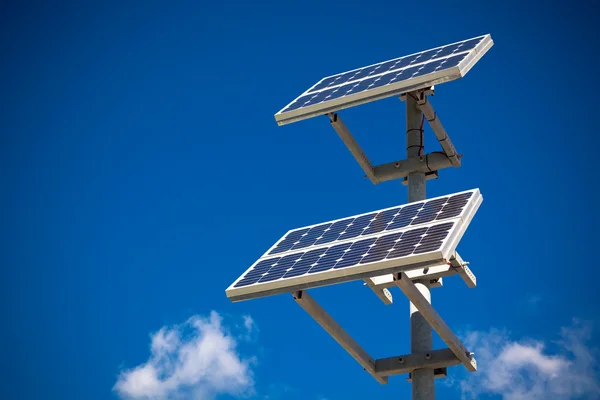 Solar panels on bright blue sky background — Stock Photo, Image