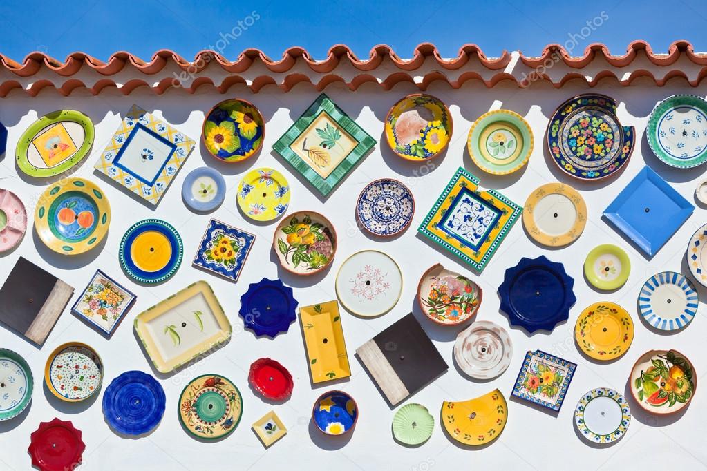 Traditional portuguese pottery plates on a wall in Algarve