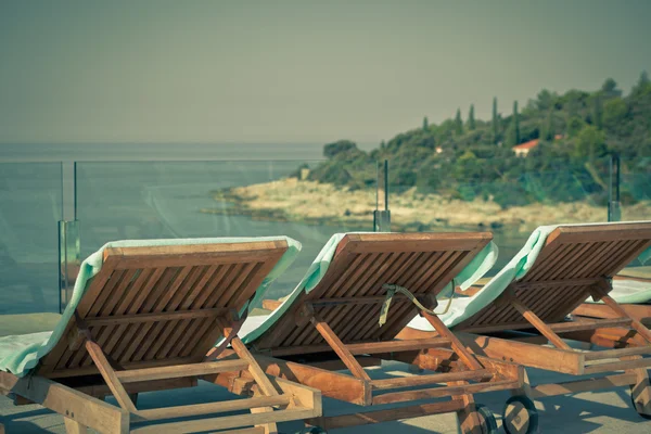 Cadeiras da piscina do hotel com vista para o mar — Fotografia de Stock