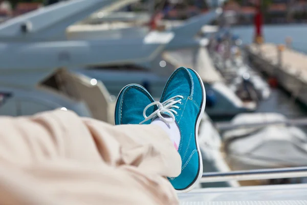 Human legs in pants and bright blue topsiders on yacht — Stock Photo, Image