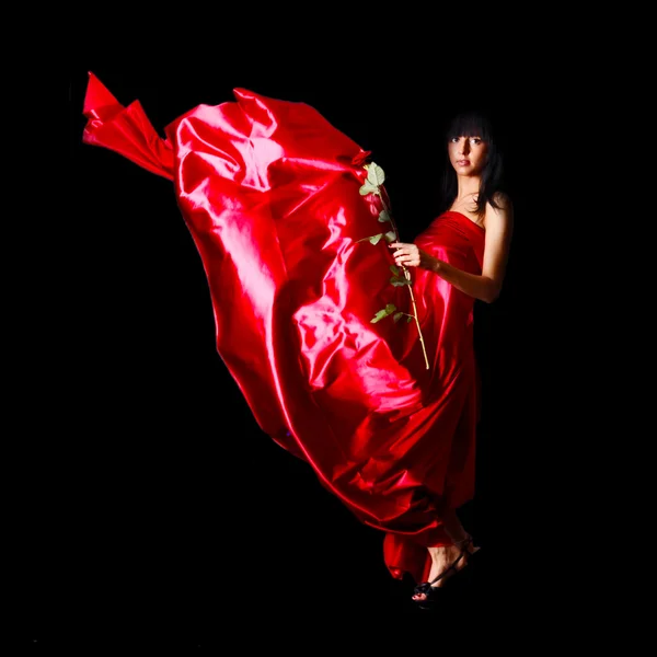 Beautiful woman in red waving flying dress — Stock Photo, Image