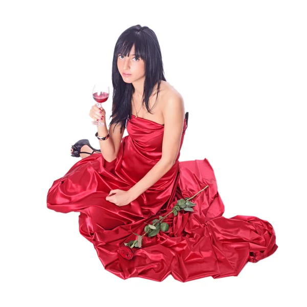 Studio portrait of a beautiful young woman holding a glass of red wine — Stock Photo, Image