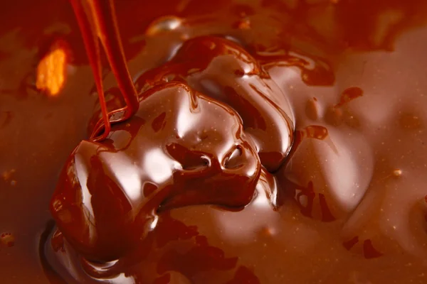 Despejando chocolate derretido quente e nozes de amêndoa — Fotografia de Stock