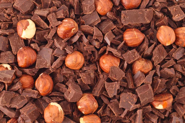 Choklad med nötter och aprikoser bakgrund — Stockfoto