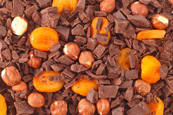 Chocolate con antecedentes de frutos secos y albaricoques — Foto de Stock