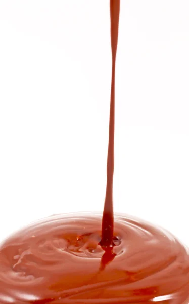 Chocolate flow isolated on white background close up — Stock Photo, Image