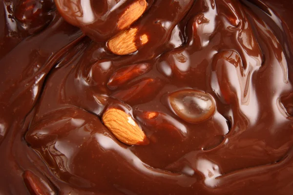 Verter chocolate caliente derretido y almendras — Foto de Stock