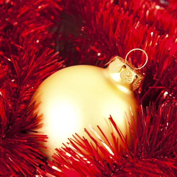 Christmas ball in red garland — Stock Photo, Image