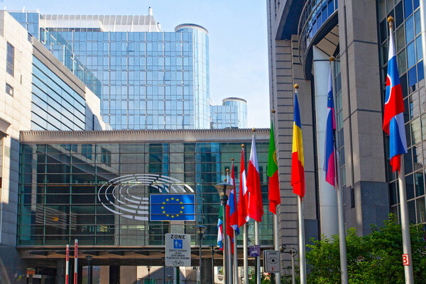 Brussels, Belgium - June 4, 2022: exterior of the European Parliament offices European flags.