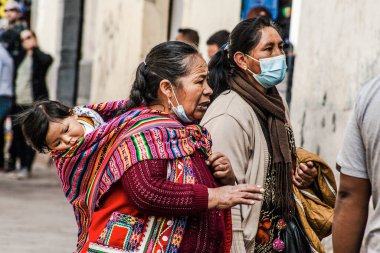 Peru - 15 Mayıs 2022: Cuzco 'da geleneksel giyinmiş Perulu insanlar. Anne ve küçük kızı. Cusco, Peru, 15 Mayıs 2022