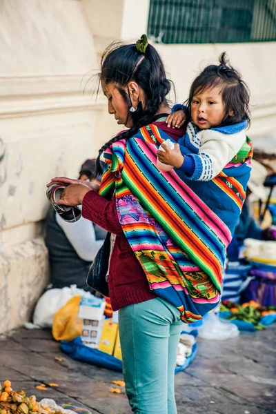 Peru - 15 Mayıs 2022: Cuzco 'da geleneksel giyinmiş Perulu insanlar. Anne ve küçük kızı. Cusco, Peru, 15 Mayıs 2022