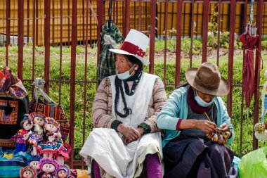 Peru - 15 Mayıs 2022: Cuzco 'da geleneksel giyinmiş Perulu insanlar. Hediyelik eşya satan bir kadın. Cusco, Peru, 15 Mayıs 2022