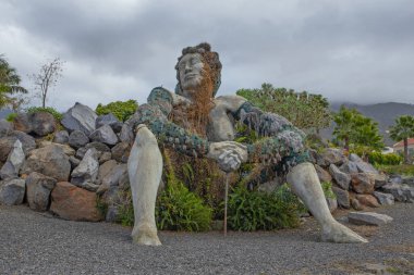 Tenerife, Canary islands - March 4, 2022: Social garden and sculpture of a giant woman in the urbanization of La Quinta on the coast of Santa Ursula