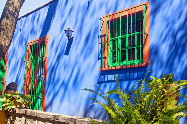 COYOACAN, MEXICO - MARCH 24, 2022: Blue House und courtyard of (La Casa Azul), historic house and art museum dedicated to the life and work of Mexican artist Frida Kahlo