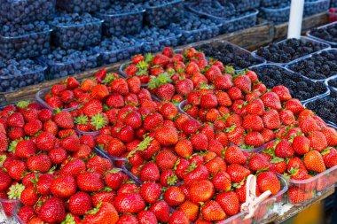 Fresh summer blueberries and strawberries on summer market