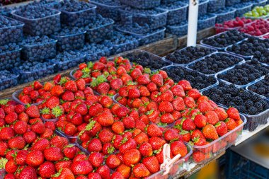 Fresh summer blueberries and strawberries on summer market