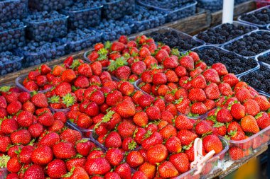 Fresh summer blueberries and strawberries on summer market