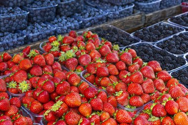 Fresh summer blueberries and strawberries on summer market