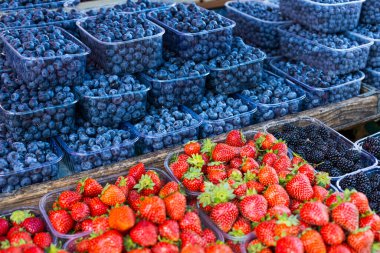 Fresh summer blueberries and strawberries on summer market