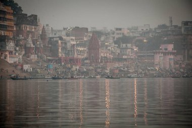VARANASI, INDIA - DECEMBER 20: Hindus perform ritual puja at dawn in the Ganges River on December 20, 2007 in Varanasi, India