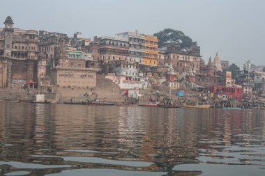 VARANASI, INDIA - DECEMBER 20: Hindus perform ritual puja at dawn in the Ganges River on December 20, 2007 in Varanasi, India