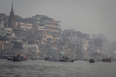 VARANASI, INDIA - DECEMBER 20: Hindus perform ritual puja at dawn in the Ganges River on December 20, 2007 in Varanasi, India